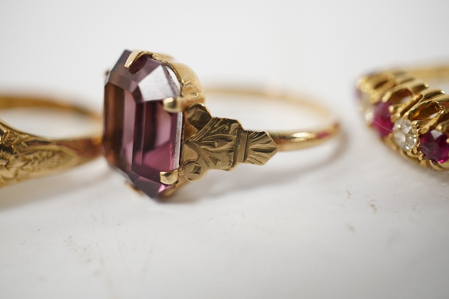 A group of four rings, comprising: a chalcedony signet ring with engraved floral shoulders, size L, partial British hallmarks for 15ct gold; a synthetic ruby and diamond five-stone ring, size N, stamped 18CT; a ring set